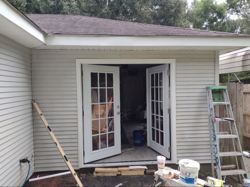 French doors installed and trimmed in a newly framed exterior opening