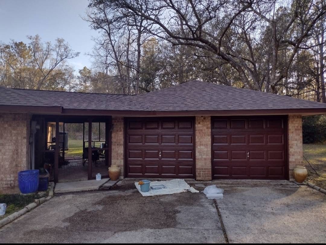 Garage doors and trim repainted on a brick home